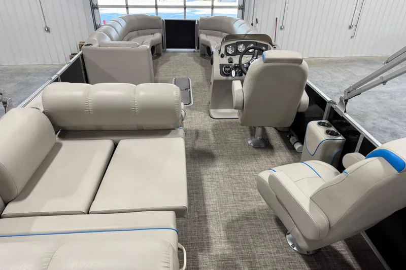 Slide: The Image of 2017 Cypress Cay Seabreeze 253 pontoon boat interior with beige seating and helm. - 9