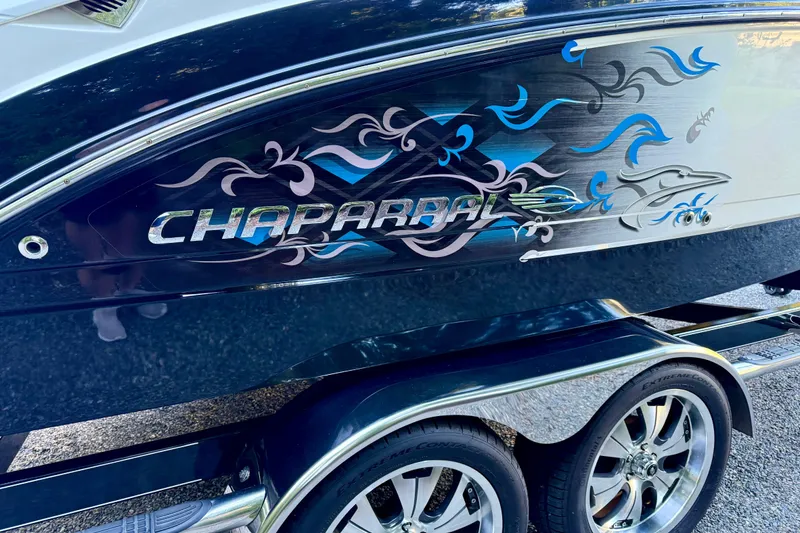 Slide: The Image of 2009 Chaparral Sunesta 224 Xtreme boat with decorative graphics on the side. - 10