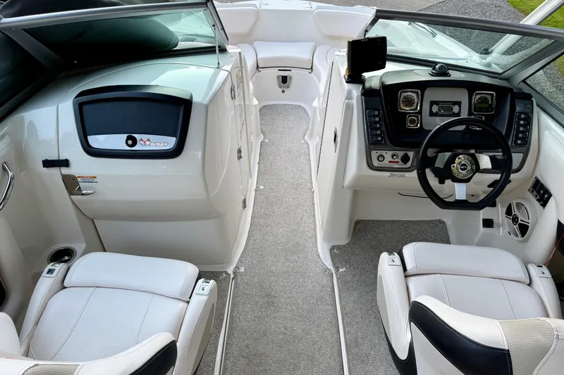 Slide: The Image of 2009 Chaparral Sunesta 224 Xtreme boat interior with steering wheel and seating. - 15