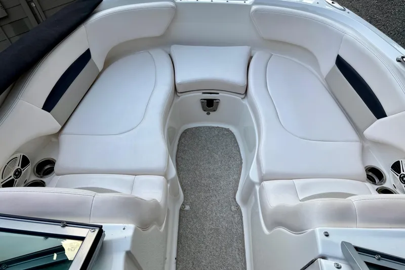 Slide: The Image of 2009 Chaparral Sunesta 224 Xtreme boat interior with white cushioned seating and speakers. - 16