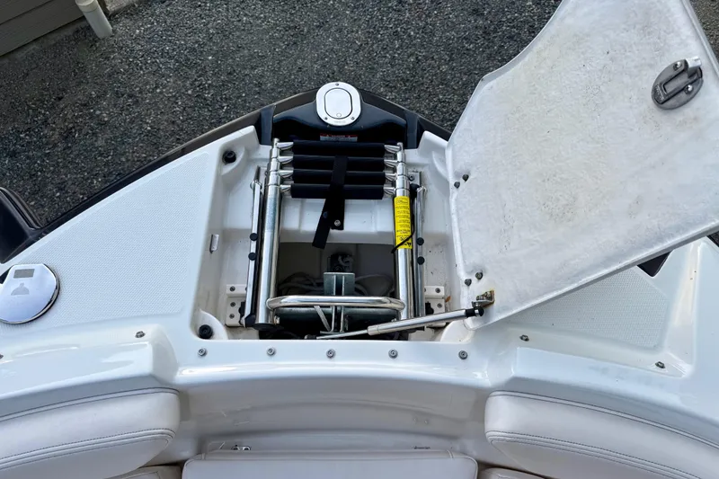 Slide: The Image of 2009 Chaparral Sunesta 224 Xtreme boat with open storage compartment and ladder. - 17