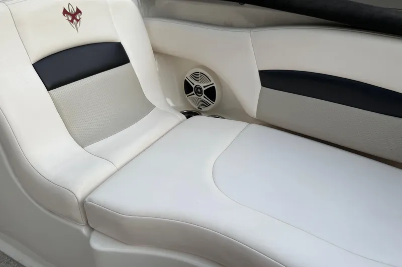 Slide: The Image of 2009 Chaparral Sunesta 224 Xtreme boat interior with white seating and speaker. - 18