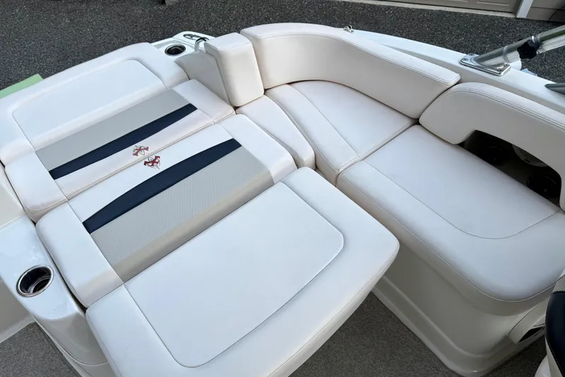 Slide: The Image of 2009 Chaparral Sunesta 224 Xtreme boat interior with white cushioned seating. - 23