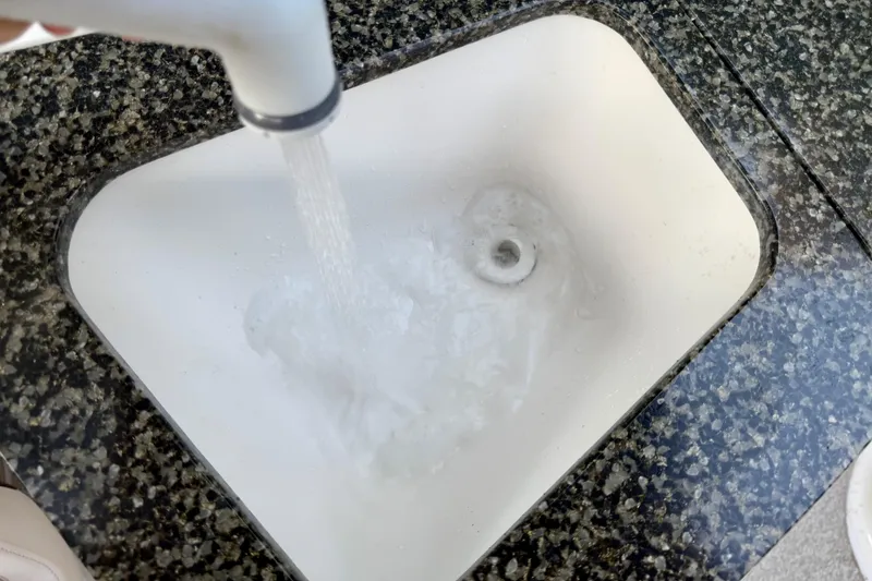 Slide: The Image of Water flowing into a white sink on a Chaparral Sunesta 224 Xtreme boat, 2009 model. - 24