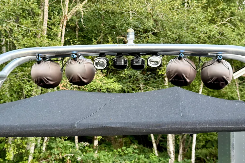 Slide: The Image of 2009 Chaparral Sunesta 224 Xtreme boat with speakers and canopy, surrounded by trees. - 25