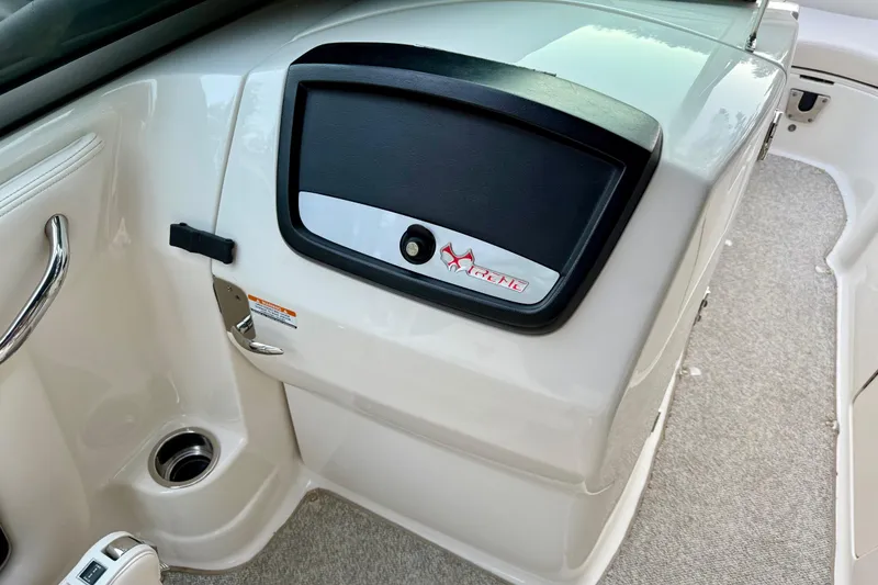 Slide: The Image of 2009 Chaparral Sunesta 224 Xtreme boat interior with glove compartment and handle. - 28