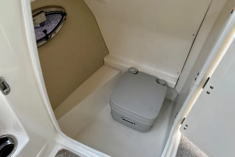 Slide: The Image of 2009 Chaparral Sunesta 224 Xtreme boat interior with portable toilet and porthole. - 29