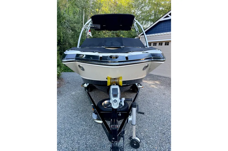 Slide: The Image of 2009 Chaparral Sunesta 224 Xtreme boat on trailer, parked in driveway. - 3