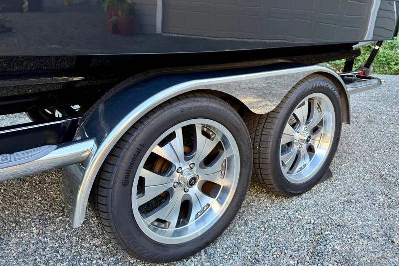 Slide: The Image of 2009 Chaparral Sunesta 224 Xtreme trailer with Continental tires on gravel. - 6
