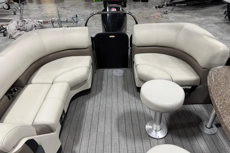 Slide: The Image of Interior of 2021 Manitou 23 Oasis pontoon boat with plush seating and modern design. - 13