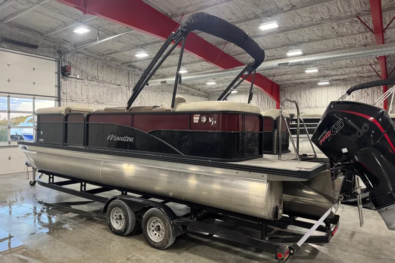 Slide: The Image of 2021 Manitou 23 Oasis pontoon boat on trailer in indoor storage facility. - 3