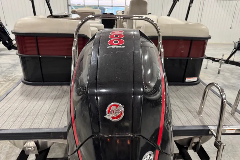 Slide: The Image of 2021 Manitou 23 Oasis pontoon boat with powerful outboard motor in a showroom. - 5