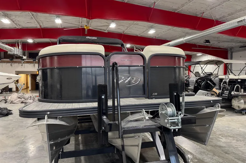 Slide: The Image of 2021 Manitou 23 Oasis pontoon boat in a showroom with red ceiling. - 8