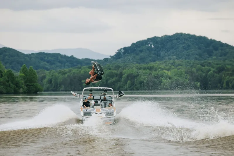 Slide: The Image of 2026 MasterCraft XT20 boat displayed at a trade show. - 2