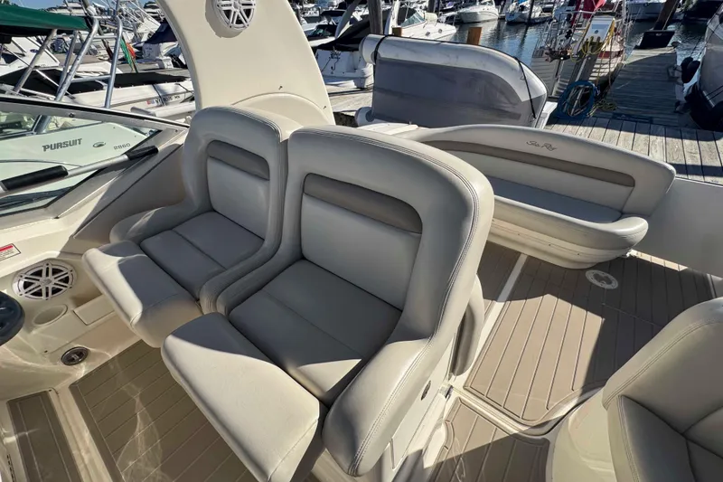 Slide: The Image of Luxury seating on a 2002 Sea Ray 320 Sundancer yacht at a marina. - 11