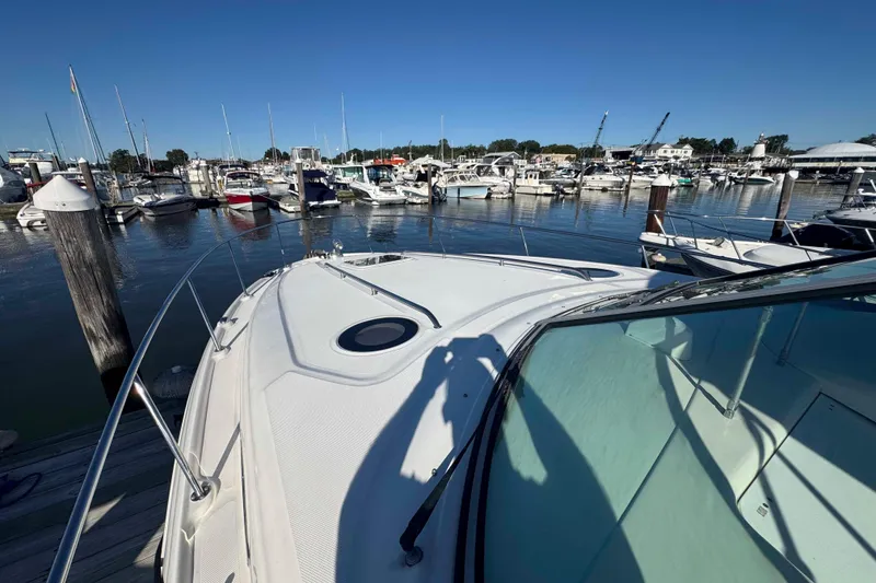 Slide: The Image of 2002 Sea Ray 320 Sundancer docked at a marina with multiple boats. - 12