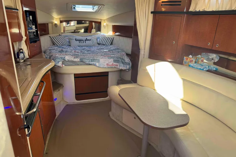 Slide: The Image of Luxurious interior of a 2002 Sea Ray 320 Sundancer yacht with cozy bed and seating area. - 15
