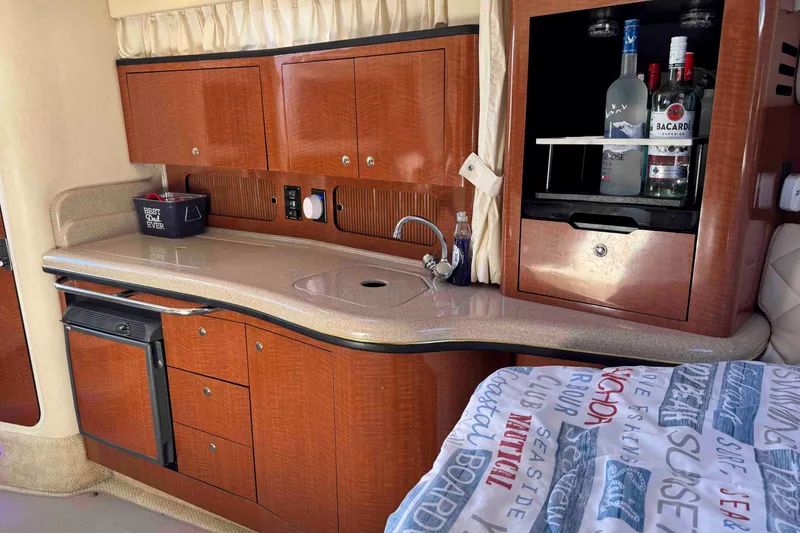 Slide: The Image of Luxurious 2002 Sea Ray 320 Sundancer cabin with kitchenette and bar area. - 17