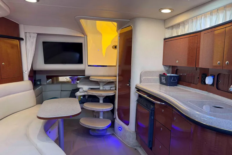 Slide: The Image of Interior of 2002 Sea Ray 320 Sundancer yacht with modern amenities and cozy seating. - 18