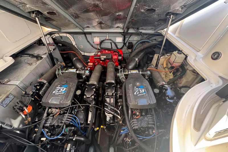 Slide: The Image of Engine compartment of a 2002 Sea Ray 320 Sundancer boat, showcasing dual engines. - 26