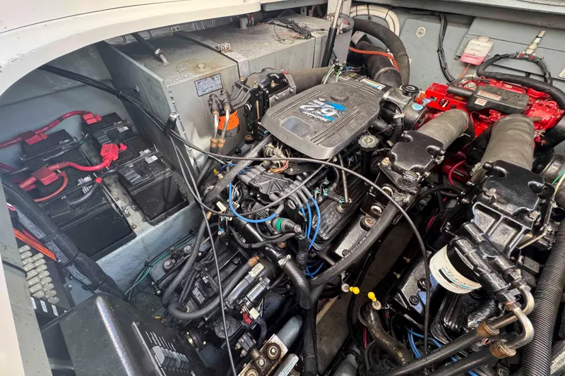Slide: The Image of Engine compartment of a 2002 Sea Ray 320 Sundancer with visible batteries and wiring. - 27