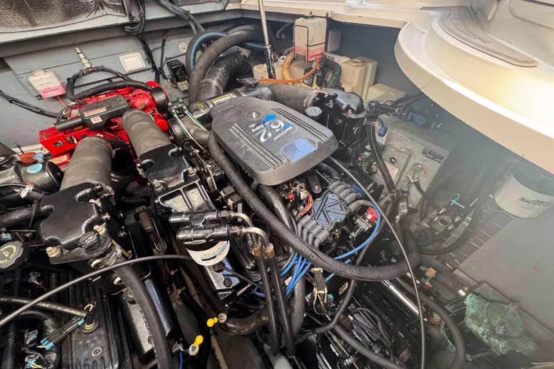 Slide: The Image of Engine compartment of a 2002 Sea Ray 320 Sundancer boat, showcasing mechanical components. - 28