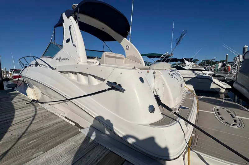 Slide: The Image of 2002 Sea Ray 320 Sundancer docked at marina under clear blue sky. - 5