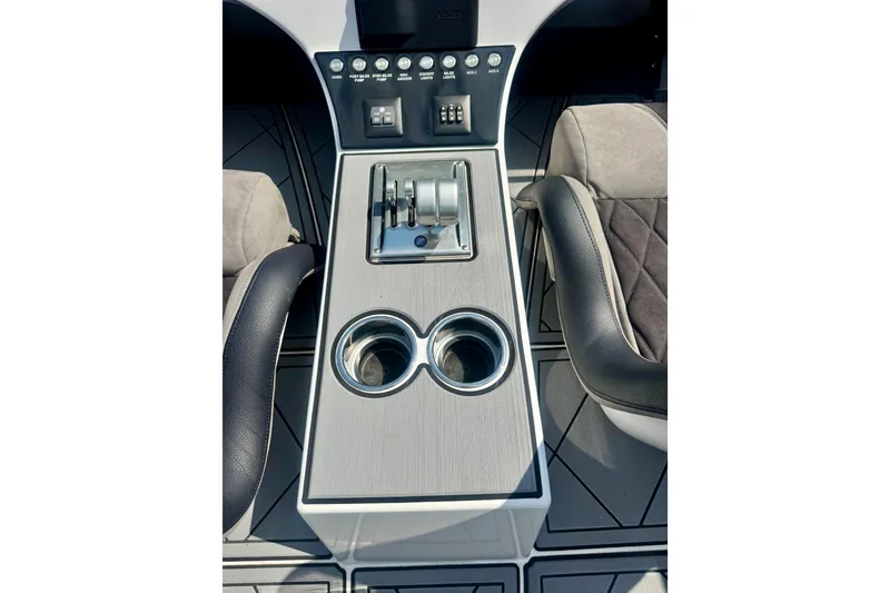 Slide: The Image of Center console of 2024 Fountain 34 Thundercat with controls and cup holders. - 10