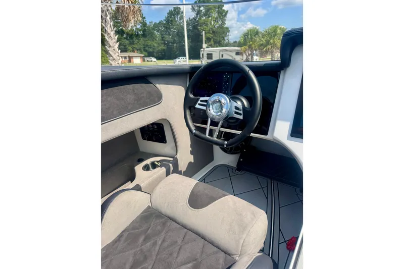 Slide: The Image of Interior of 2024 Fountain 34 Thundercat boat, featuring sleek steering wheel and modern dashboard. - 12