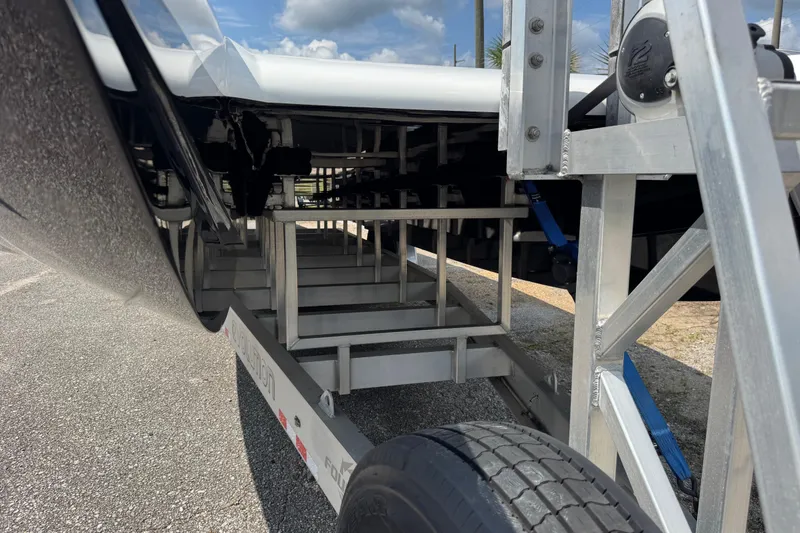 Slide: The Image of 2024 Fountain 34 Thundercat boat trailer detail with metal framework and tire. - 18