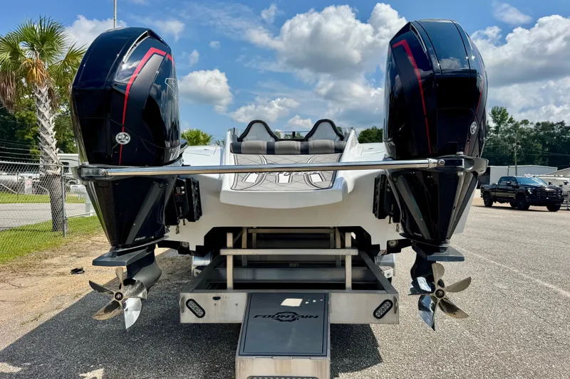 Slide: The Image of 2024 Fountain 34 Thundercat boat with dual outboard engines, parked outdoors. - 4