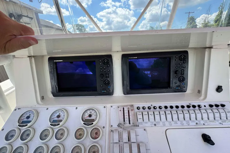 Slide: The Image of 2008 Fountain 38 Tournament Edition boat dashboard with navigation screens and gauges. - 10