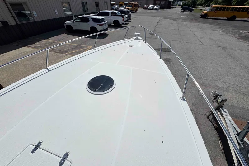 Slide: The Image of 2008 Fountain 38 Tournament Edition boat deck in a parking lot with vehicles. - 14