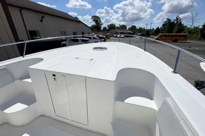 Slide: The Image of 2008 Fountain 38 Tournament Edition boat deck under a sunny sky, parked near buildings. - 15