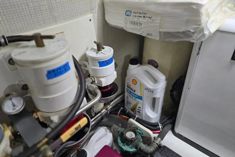 Slide: The Image of Engine room of 2005 American Tug 34 Pilothouse with oil filters and Shell Rotella T4 oil. - 107