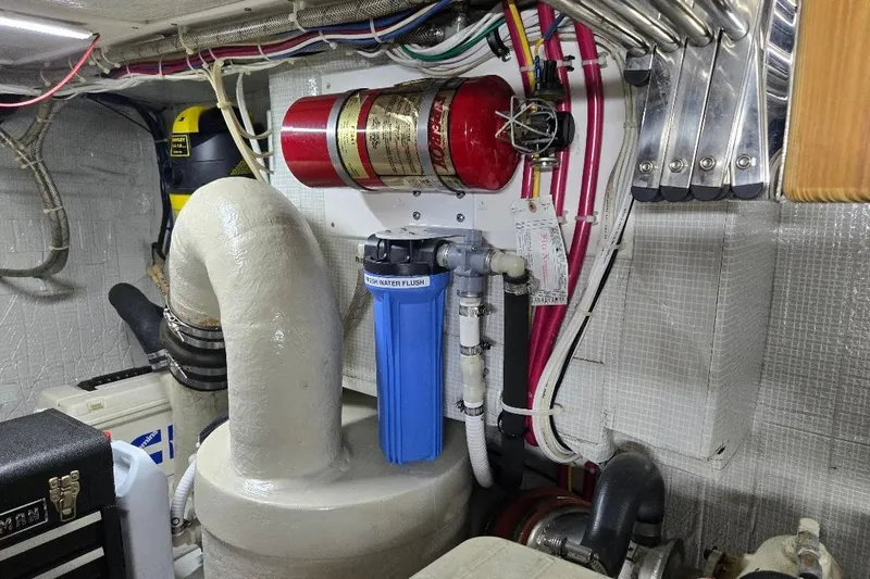 Slide: The Image of Engine room of 2005 American Tug 34 Pilothouse with fire extinguisher and water filter system. - 114