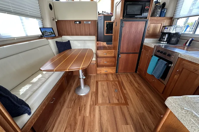 Slide: The Image of Interior of 2005 American Tug 34 Pilothouse with wood flooring and modern kitchen amenities. - 13