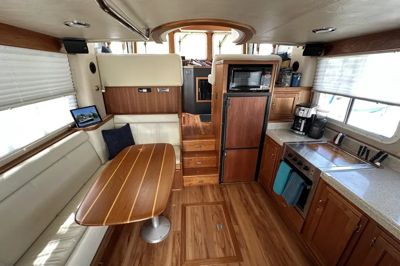 Slide: The Image of Interior of 2005 American Tug 34 Pilothouse with kitchen and dining area. - 2