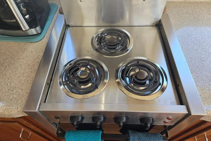 Slide: The Image of Stainless steel electric stove with three burners on American Tug 34 Pilothouse, 2005 model. - 24