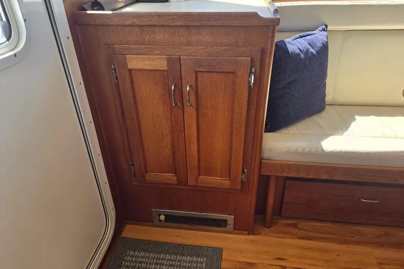 Slide: The Image of Wooden cabinet and seating area inside a 2005 American Tug 34 Pilothouse boat. - 30
