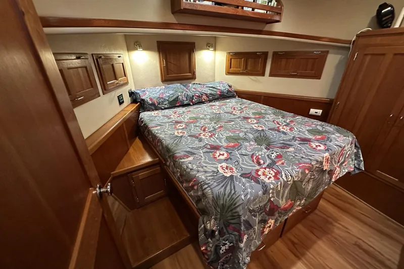 Slide: The Image of Cozy bedroom in 2005 American Tug 34 Pilothouse with floral bedding and wooden cabinetry. - 33