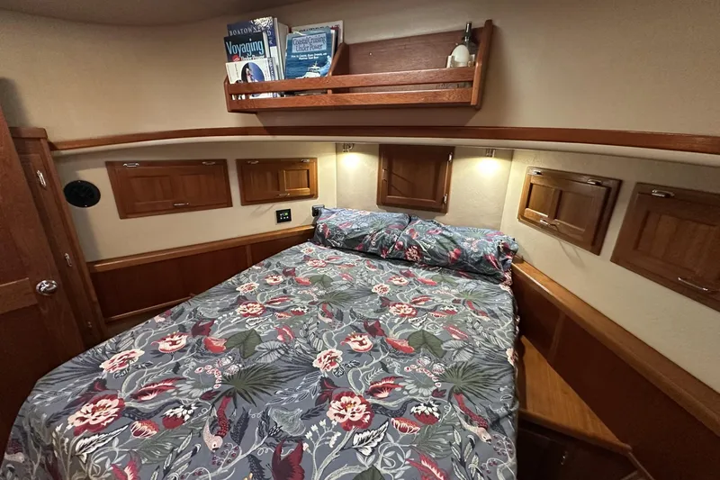 Slide: The Image of Cozy cabin interior of 2005 American Tug 34 Pilothouse with floral bedding and wooden accents. - 35