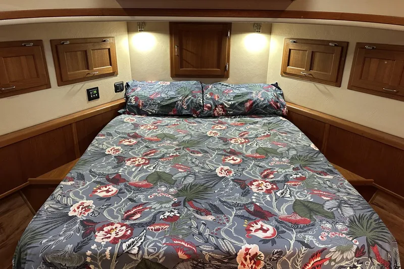 Slide: The Image of Cozy cabin bedroom in 2005 American Tug 34 Pilothouse with floral bedding and wooden accents. - 36