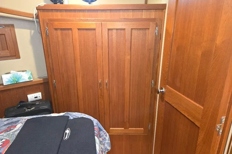 Slide: The Image of Interior of 2005 American Tug 34 Pilothouse with wooden cabinetry and door. - 37