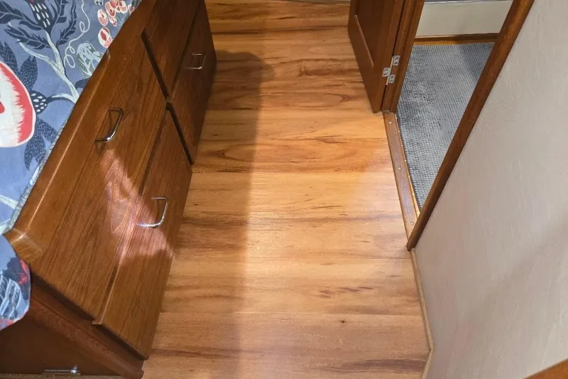 Slide: The Image of Interior of 2005 American Tug 34 Pilothouse with wooden flooring and storage drawers. - 38