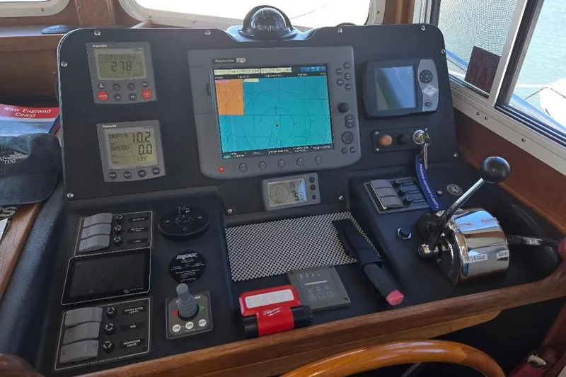 Slide: The Image of 2005 American Tug 34 Pilothouse dashboard with navigation and control instruments. - 46