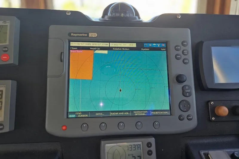 Slide: The Image of Navigation system on 2005 American Tug 34 Pilothouse displaying radar and GPS data. - 47