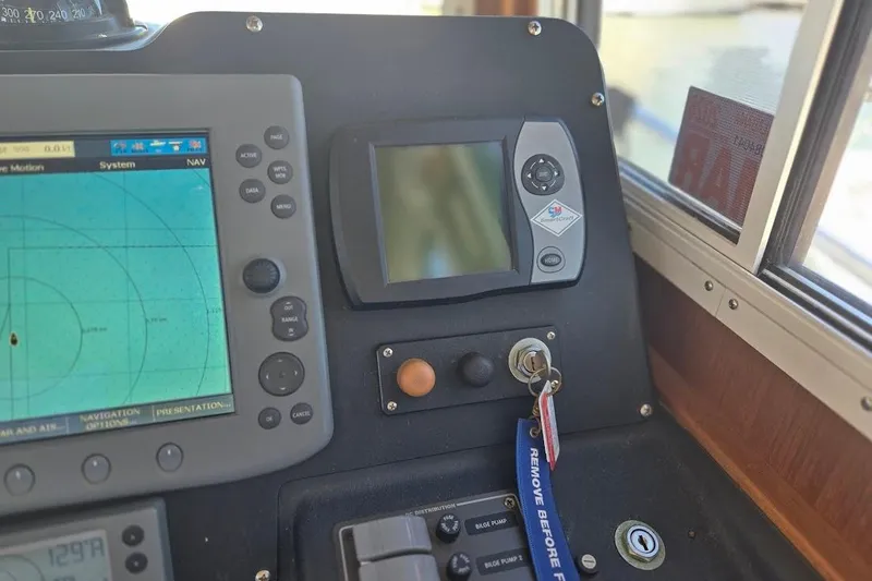 Slide: The Image of Control panel of a 2005 American Tug 34 Pilothouse with navigation display. - 49