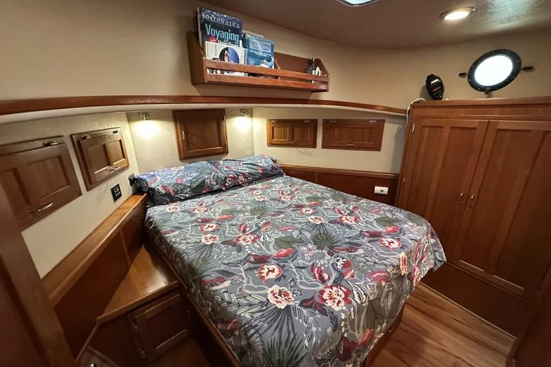 Slide: The Image of Cozy bedroom in 2005 American Tug 34 Pilothouse with floral bedding and wooden cabinetry. - 5