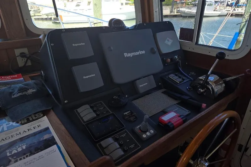 Slide: The Image of Pilothouse of 2005 American Tug 34 with Raymarine navigation equipment and controls. - 54